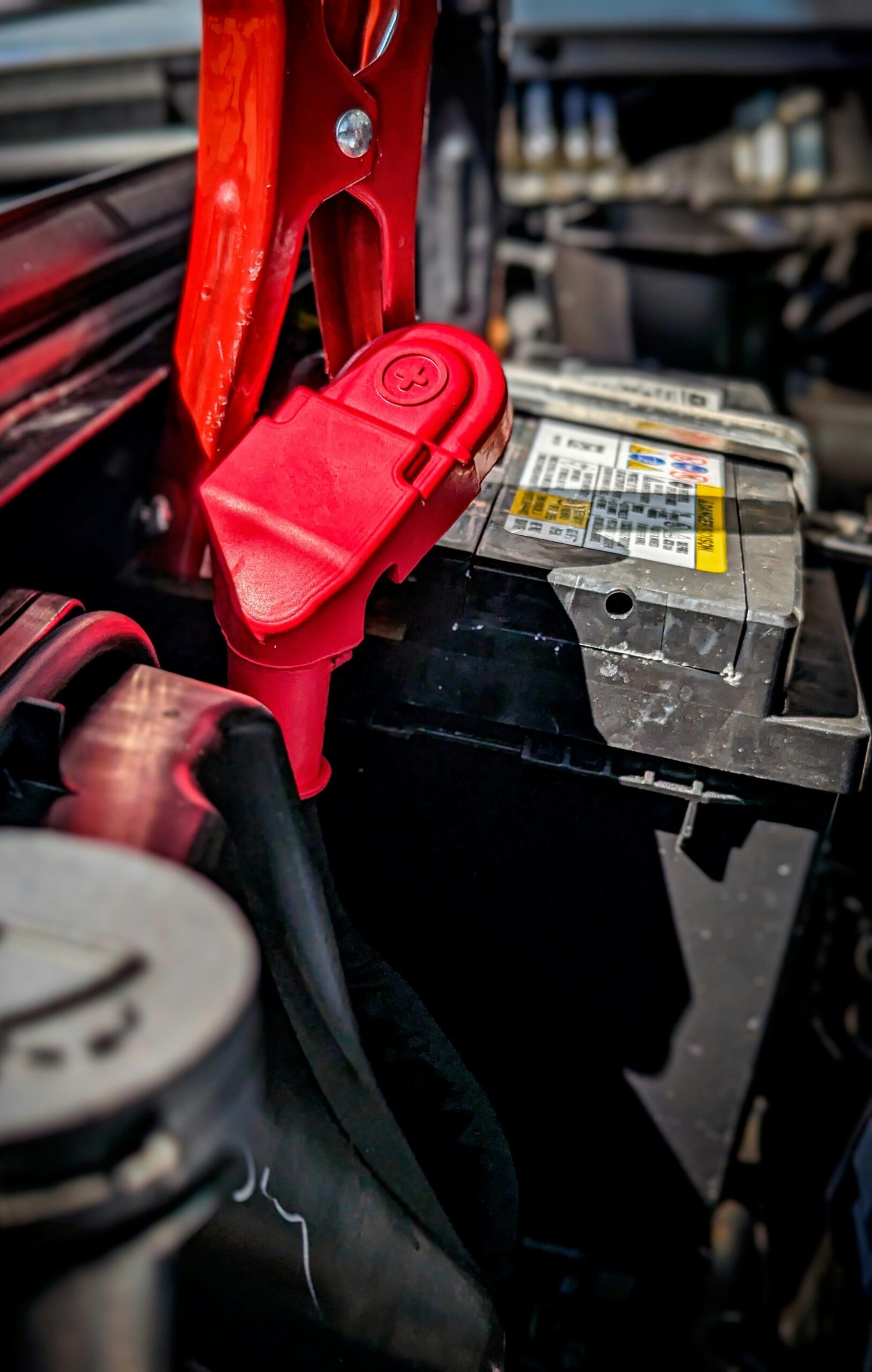 a red pair of pliers sitting on top of a car